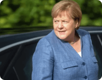 The Merkel is standing in front of the car
